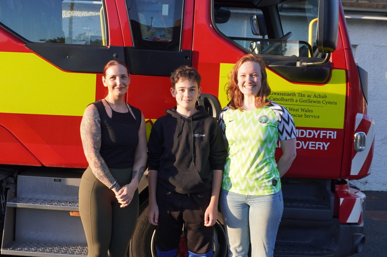 András with Kirsty Williams and Ella Peel beside a fire engine.