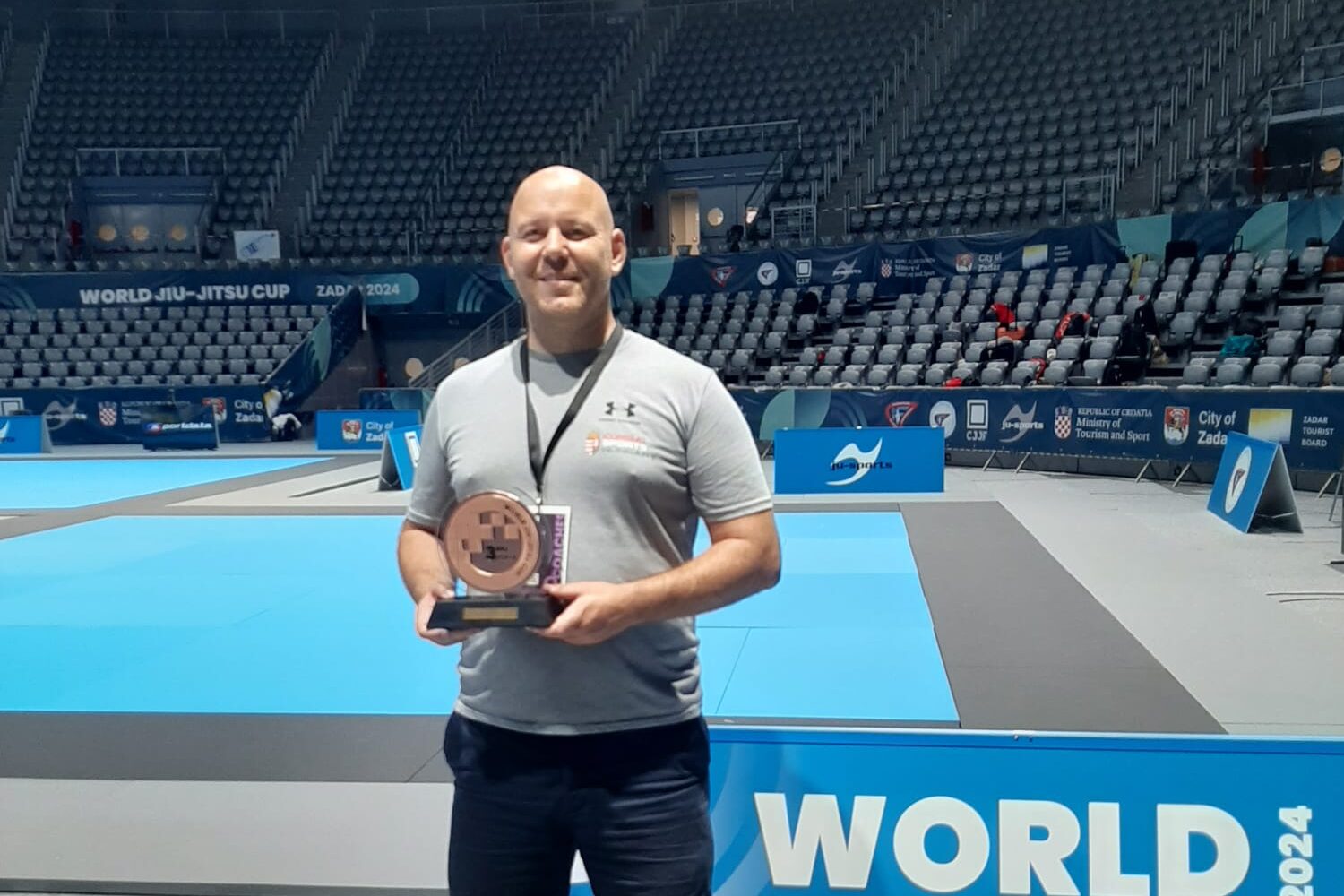 Dr Csaba Spalovszky holding a trophy at the World Nations Jiu-Jitsu Cup.